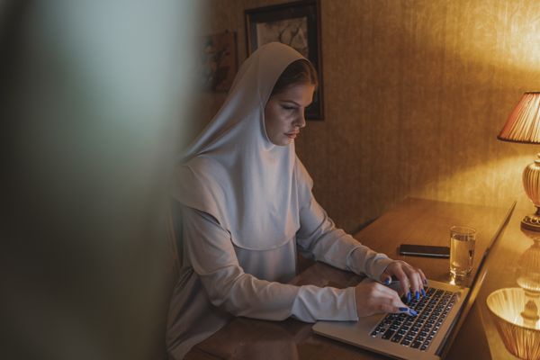 Coach working with laptop
