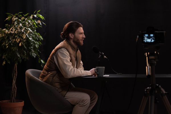 Two hosts filming a studio interview